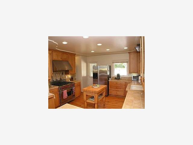 2935 Ribera Road Carmel, CA 93923 - Photo 4 of 5 a living room with stainless steel appliances kitchen island granite countertop a sink and cabinets