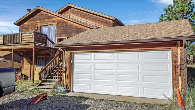 a view of a house with a yard and a garden