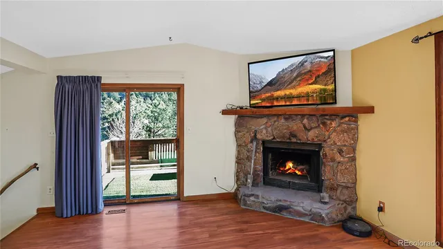 a living room with a fireplace and a wooden floor