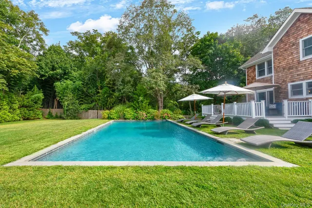 a view of a house with swimming pool and yard