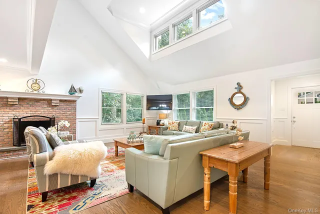 a living room with furniture a fireplace and a large window