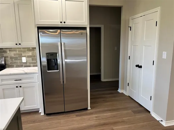 a kitchen with sink stove and refrigerator