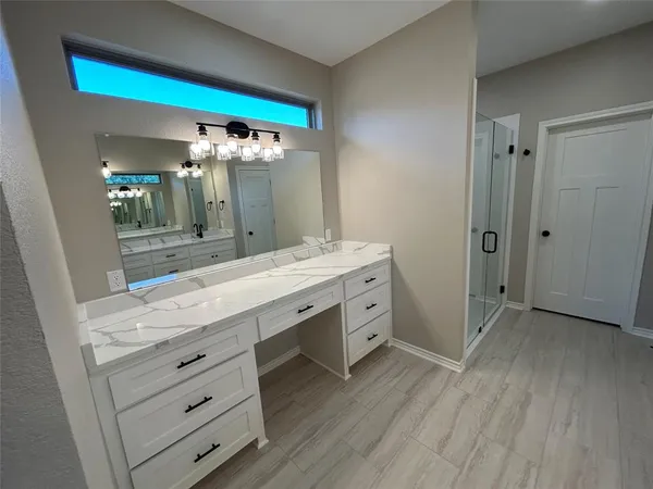 a bathroom with a double vanity sink and a mirror