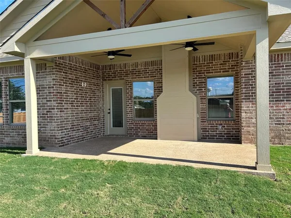 a view of house with backyard and glass door
