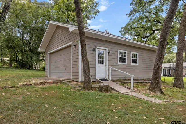 a view of backyard of house with green space