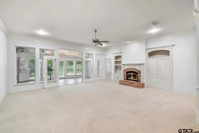 a view of a livingroom with a fireplace and window