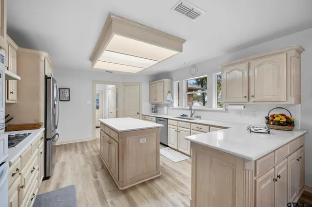 a kitchen with stainless steel appliances granite countertop a stove and a sink