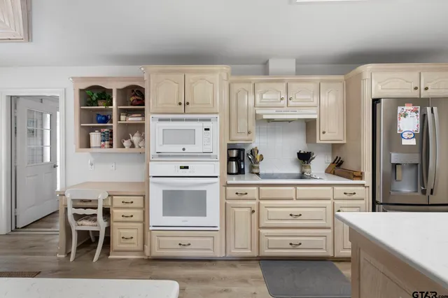 a kitchen with granite countertop a cabinets and appliances