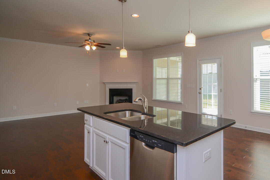 1803 Grandmaster Way Wake Forest, NC 27587 - Photo 4 of 26 a kitchen with a sink a chandelier and wooden floor