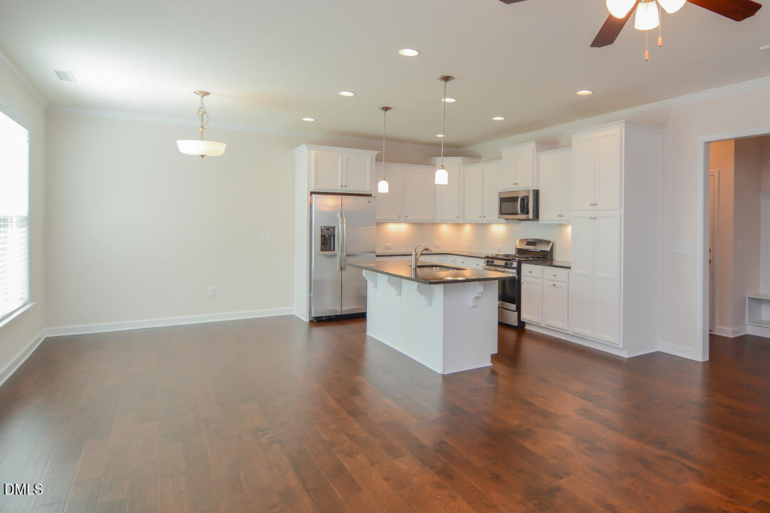 1803 Grandmaster Way Wake Forest, NC 27587 - Photo 8 of 26 a view of kitchen with kitchen island and stainless steel appliances