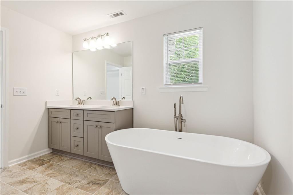 425 Boynton Road Hampton, GA 30228 - Photo 34 of 53 a white bath tub sitting in a bathroom and sink