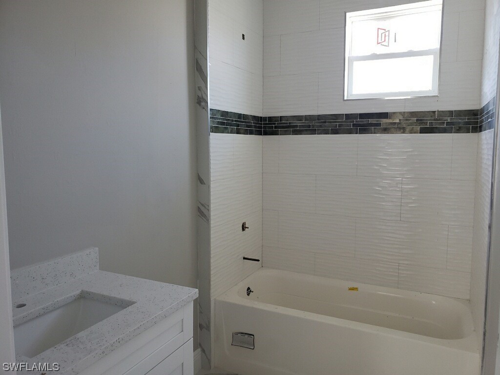 2715 50th Street Southwest Lehigh Acres, FL 33976 - Photo 13 of 16 a bathroom with a shower and a bathtub