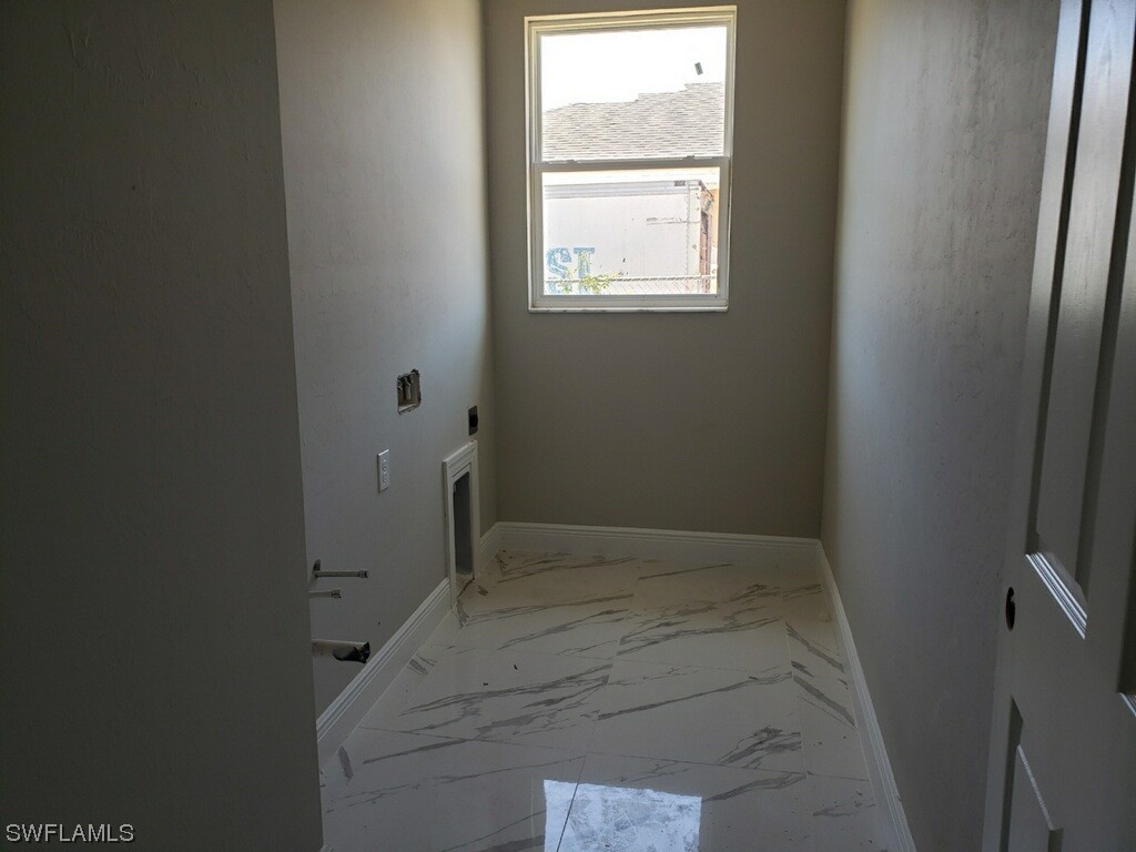 2715 50th Street Southwest Lehigh Acres, FL 33976 - Photo 14 of 16 an empty room with a window