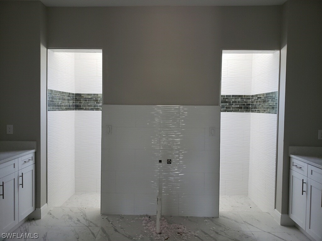 2715 50th Street Southwest Lehigh Acres, FL 33976 - Photo 15 of 16 a bathroom with a granite countertop shower and a sink