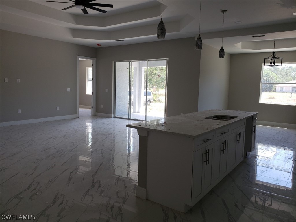 2715 50th Street Southwest Lehigh Acres, FL 33976 - Photo 4 of 16 a kitchen that has a sink a stove and a window