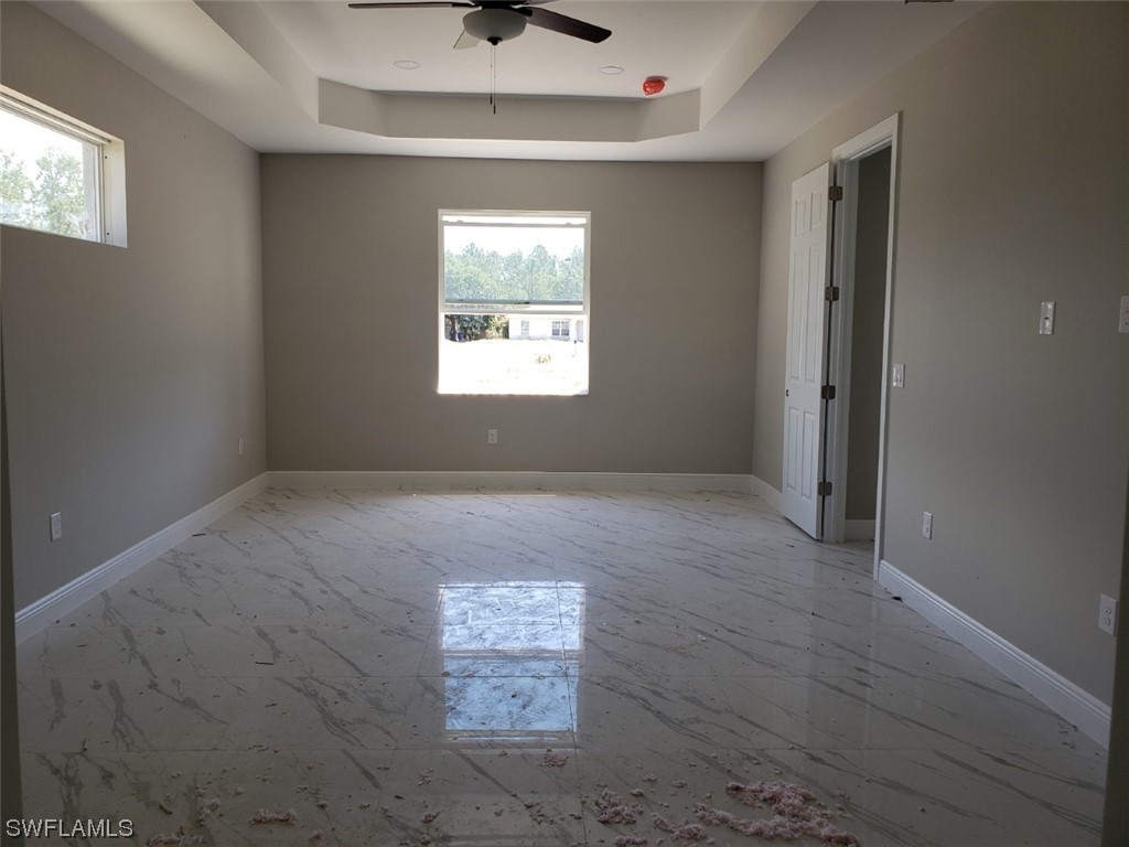 2715 50th Street Southwest Lehigh Acres, FL 33976 - Photo 5 of 16 an empty room with windows