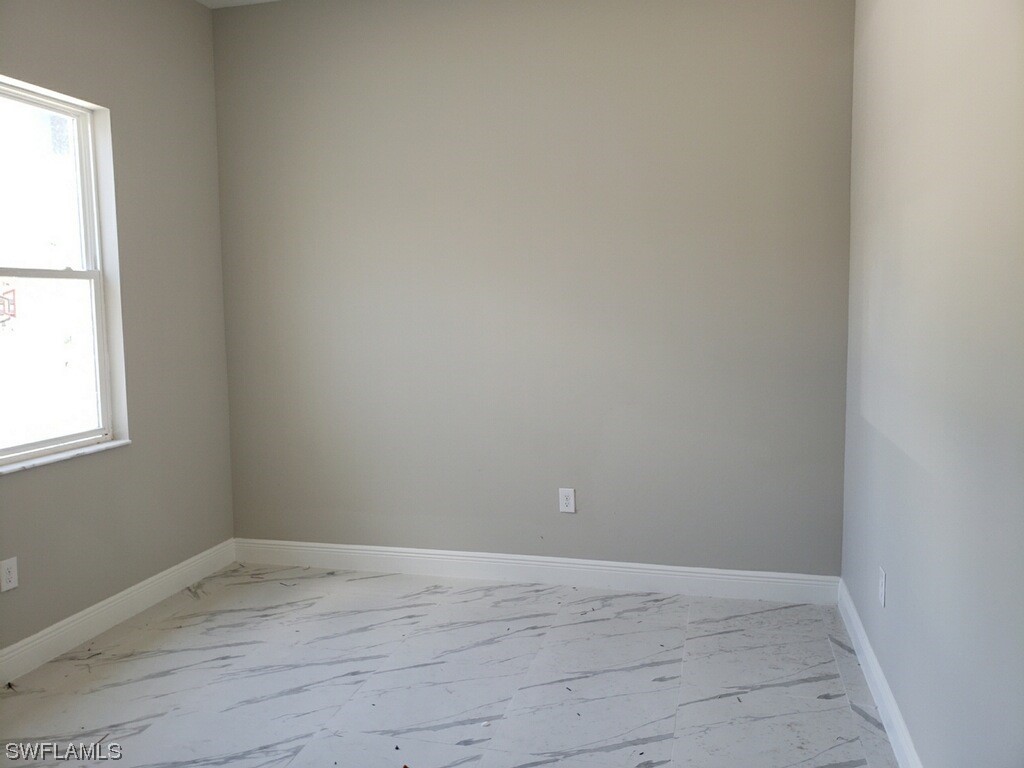 2715 50th Street Southwest Lehigh Acres, FL 33976 - Photo 10 of 16 an empty room with a window