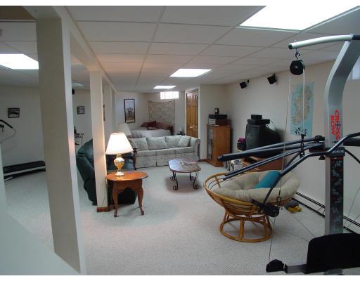 170 Still River Road Bolton, MA 01740 - Photo 8 of 15 a living room with furniture a rug and a chandelier