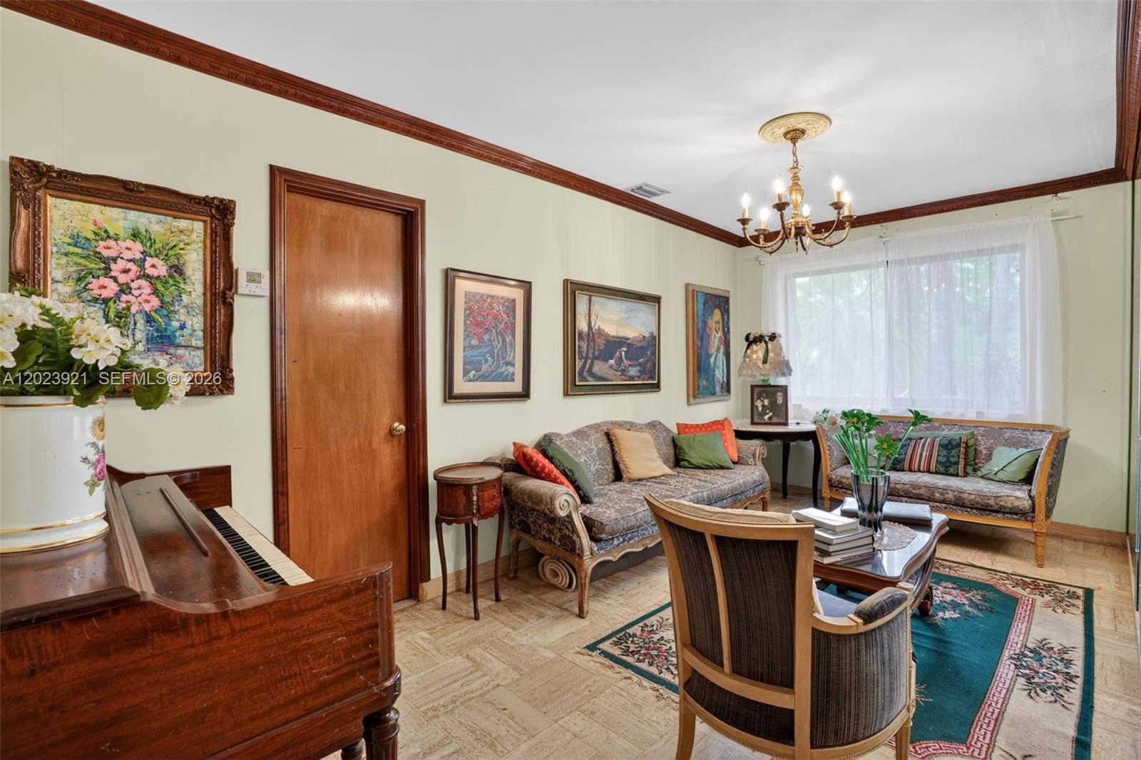 8461 Southwest 68th St Road Miami, FL 33143 - Photo 57 of 65 a living room with furniture a chandelier and a dining room