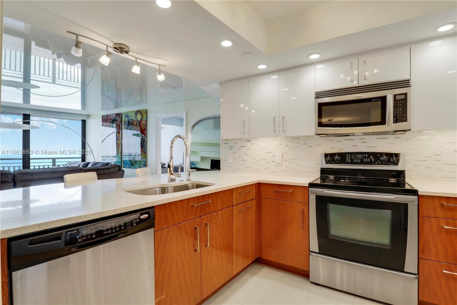 3000 North Ocean Drive, Unit PHD Singer Island, FL 33404 - Photo 17 of 97 a kitchen with stainless steel appliances a stove sink microwave and cabinets