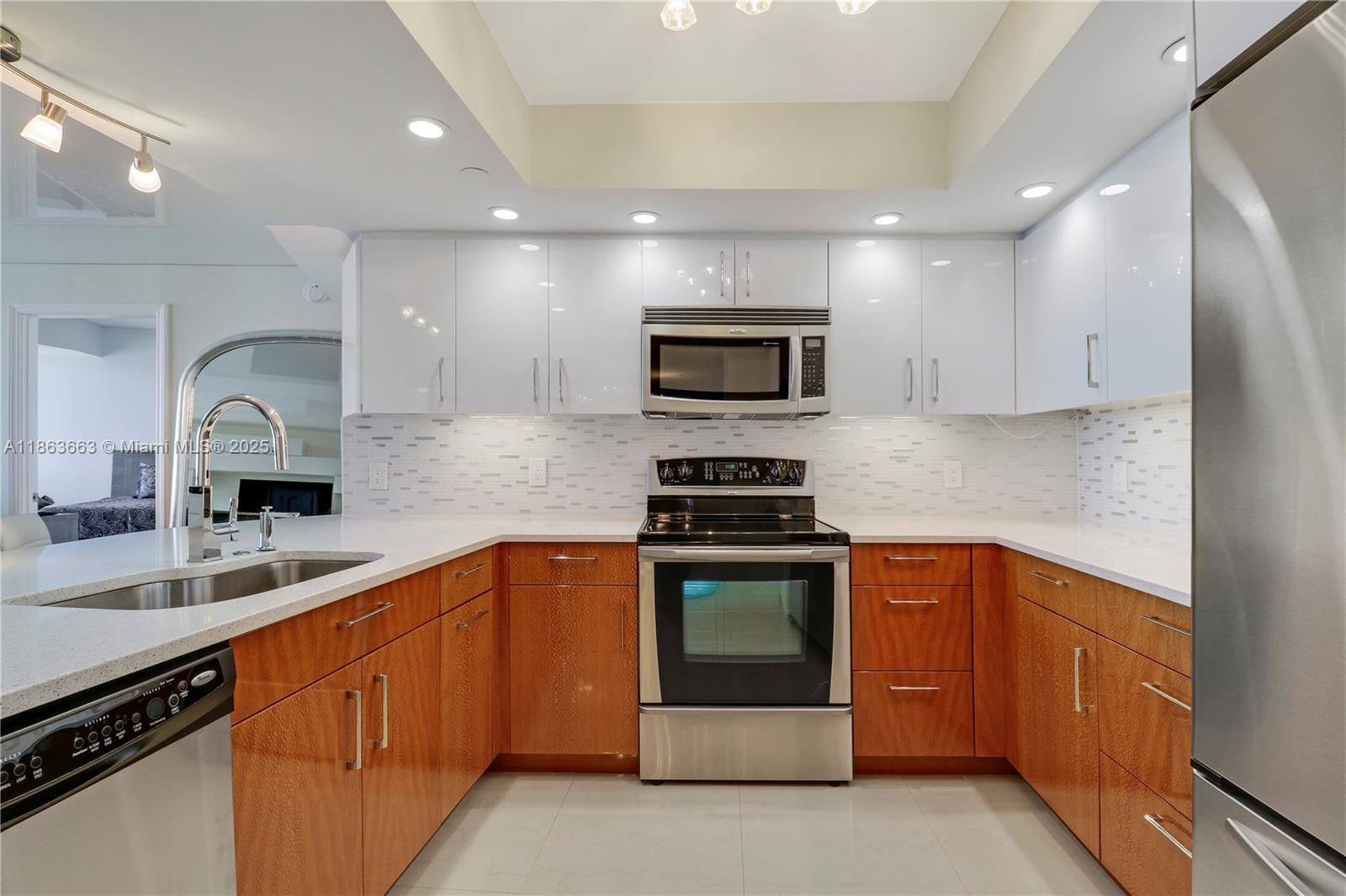 3000 North Ocean Drive, Unit PHD Singer Island, FL 33404 - Photo 18 of 97 a kitchen with stainless steel appliances granite countertop a sink and stove top oven