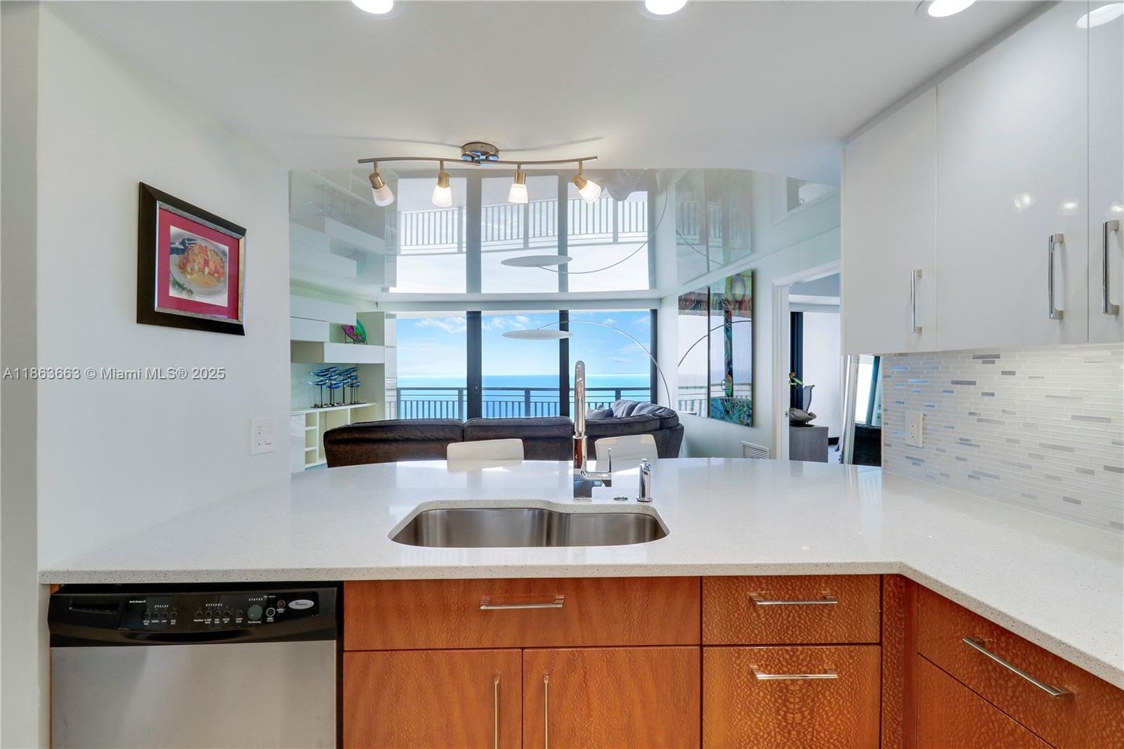 3000 North Ocean Drive, Unit PHD Singer Island, FL 33404 - Photo 19 of 97 a kitchen with stainless steel appliances a sink a stove and a refrigerator