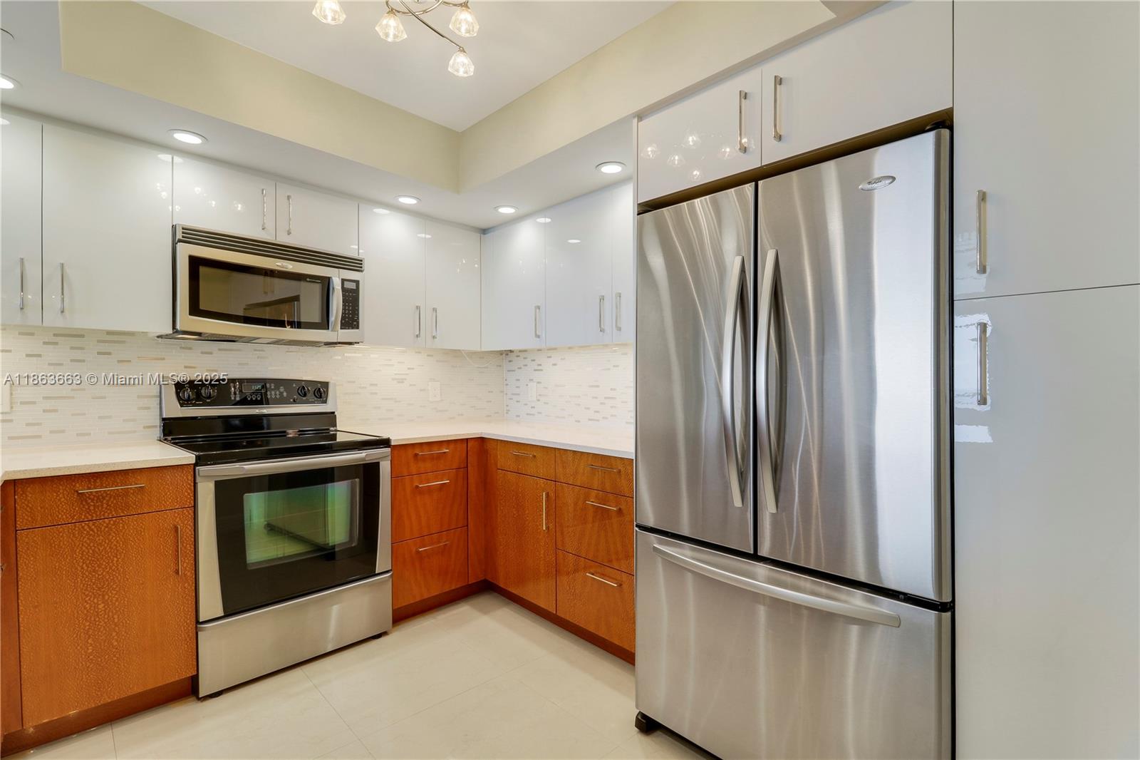 3000 North Ocean Drive, Unit PHD Singer Island, FL 33404 - Photo 21 of 97 a kitchen with stainless steel appliances granite countertop a refrigerator stove and microwave