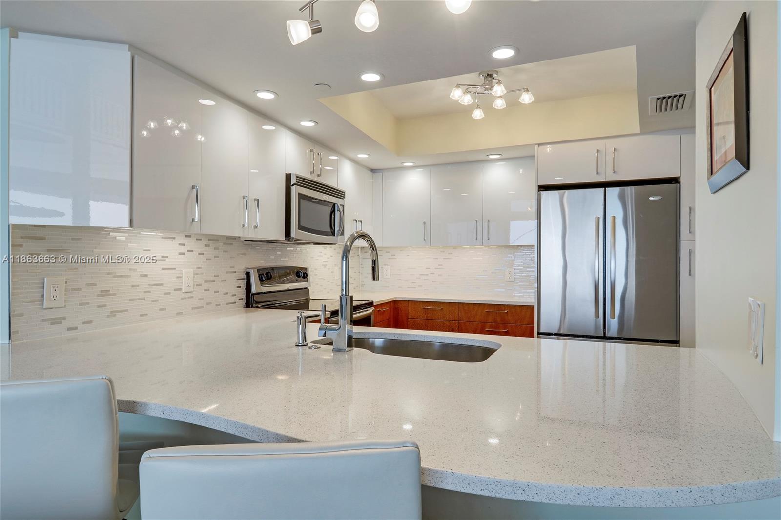 3000 North Ocean Drive, Unit PHD Singer Island, FL 33404 - Photo 24 of 97 a kitchen with stainless steel appliances granite countertop a sink and a refrigerator