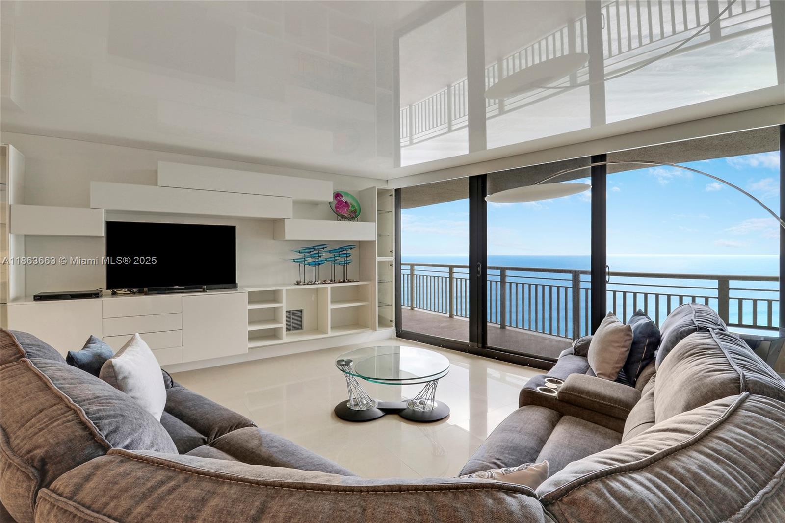 3000 North Ocean Drive, Unit PHD Singer Island, FL 33404 - Photo 31 of 97 a living room with furniture and a flat screen tv