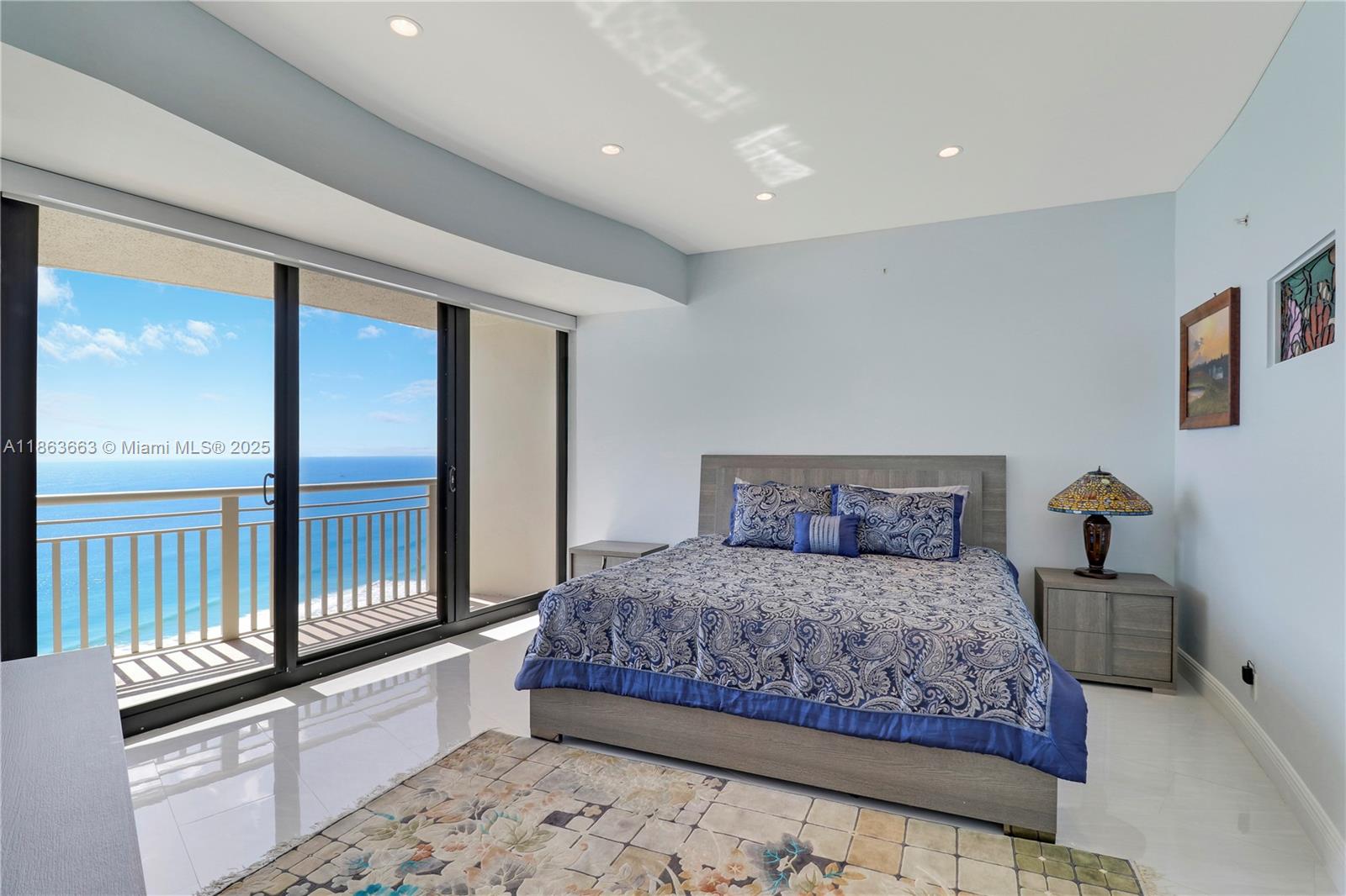 3000 North Ocean Drive, Unit PHD Singer Island, FL 33404 - Photo 43 of 97 a bedroom with a bed and a dresser with mirror