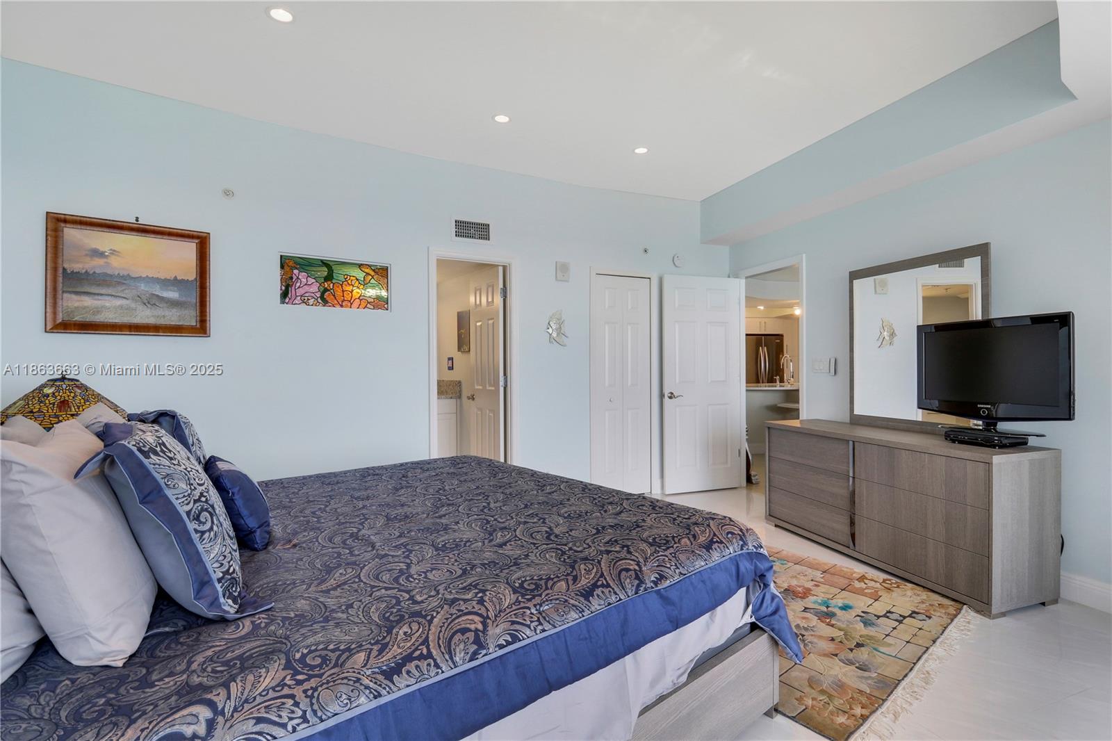 3000 North Ocean Drive, Unit PHD Singer Island, FL 33404 - Photo 46 of 97 a bedroom with a bed and a flat screen tv