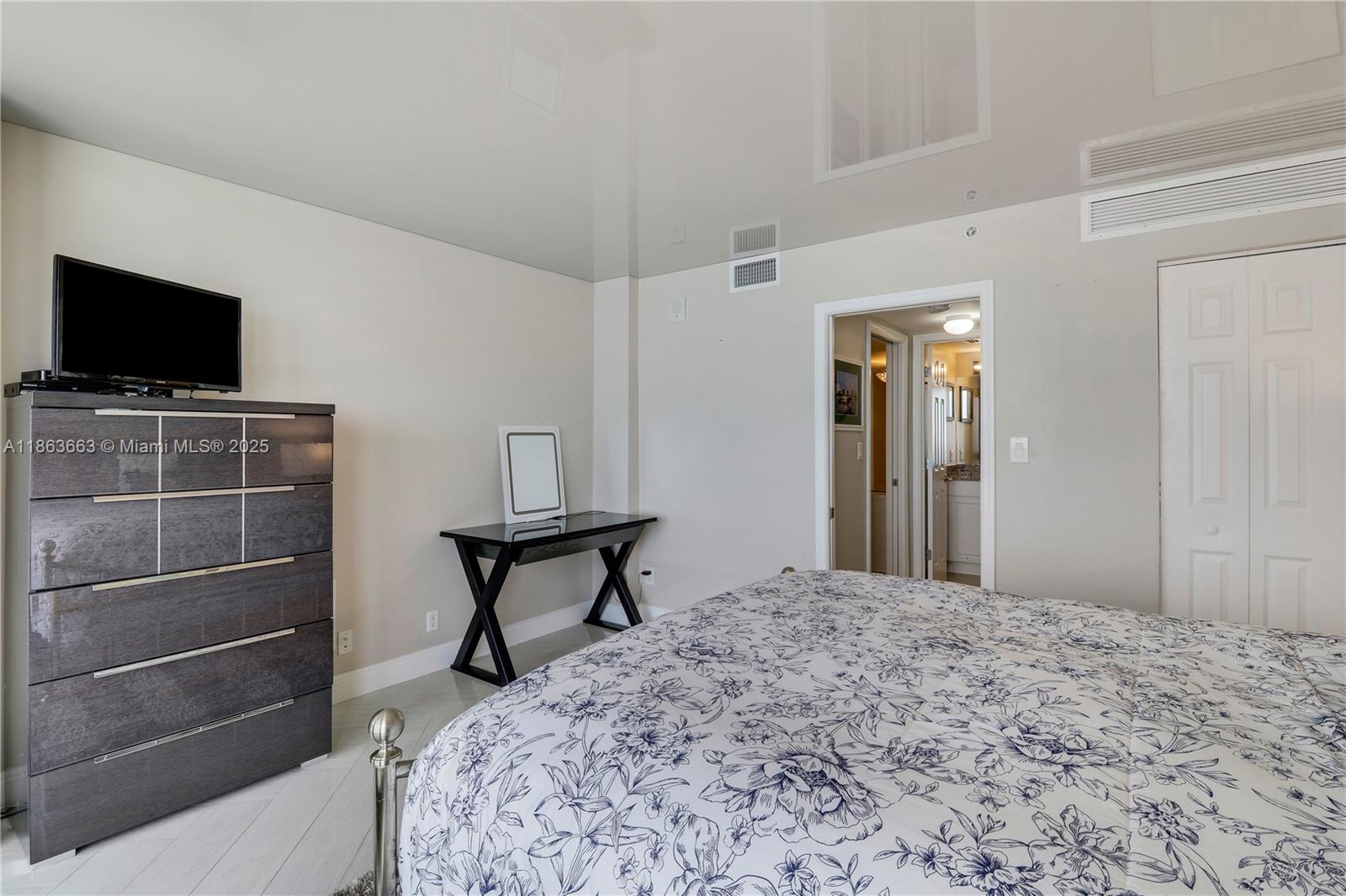 3000 North Ocean Drive, Unit PHD Singer Island, FL 33404 - Photo 54 of 97 a bedroom with a bed and a flat screen tv