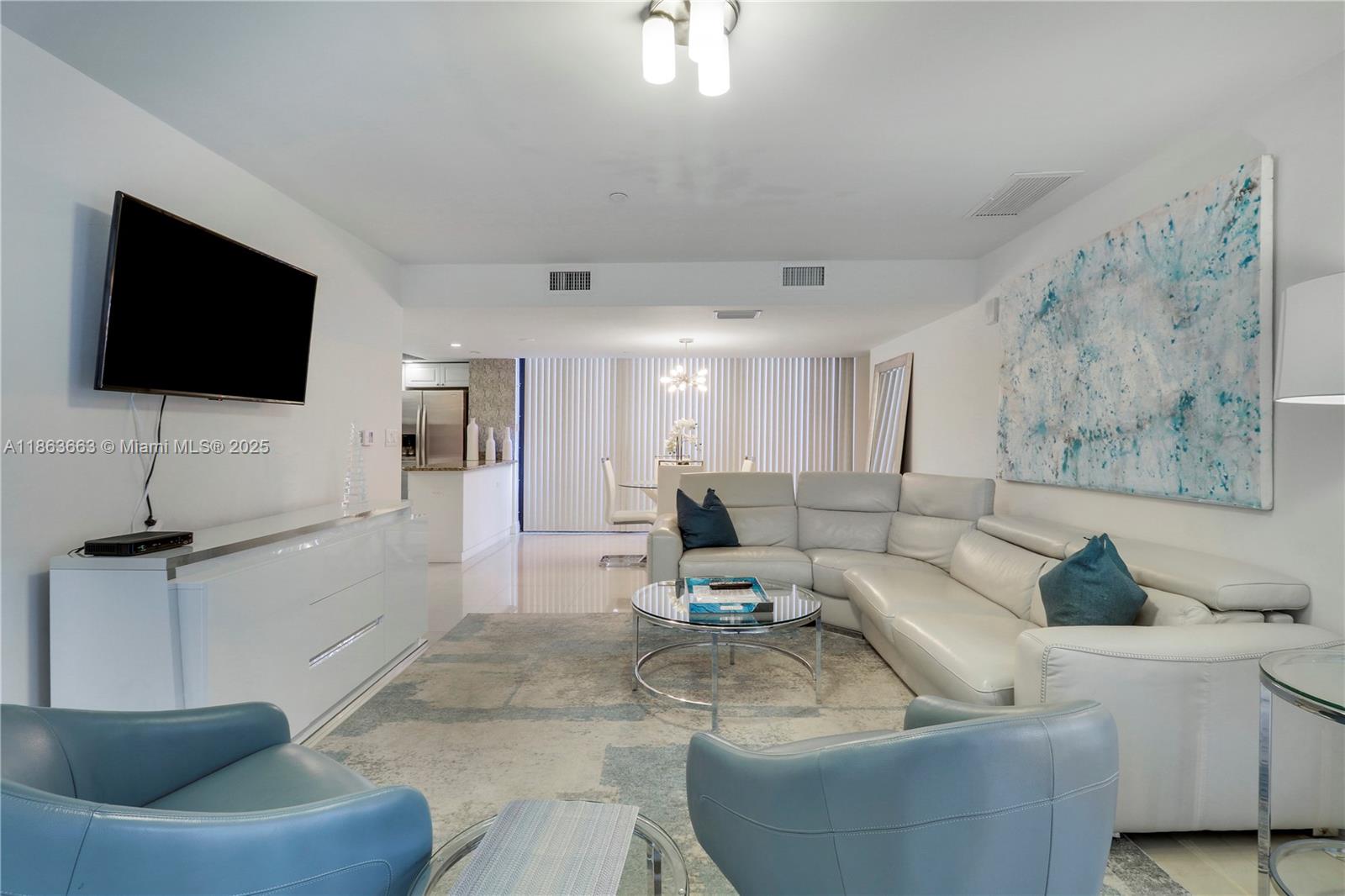 3000 North Ocean Drive, Unit PHD Singer Island, FL 33404 - Photo 68 of 97 a living room with furniture and a flat screen tv