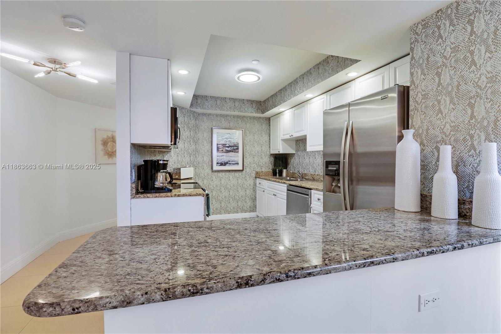 3000 North Ocean Drive, Unit PHD Singer Island, FL 33404 - Photo 69 of 97 a kitchen with stainless steel appliances granite countertop a sink a stove and a refrigerator