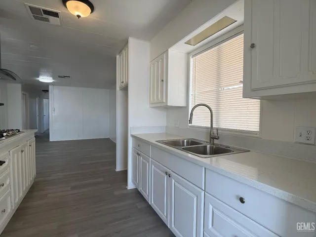 a kitchen with sink and cabinets