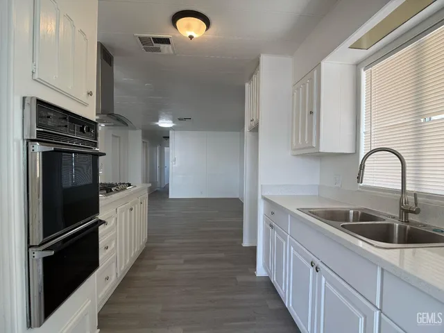 a kitchen with a sink and stainless steel appliances