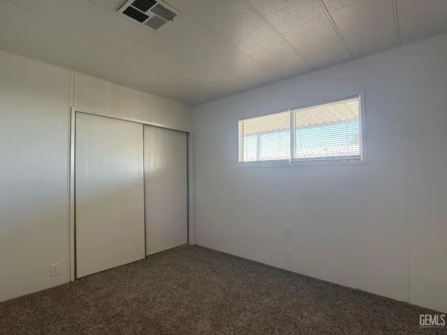 an empty room with a empty space and windows
