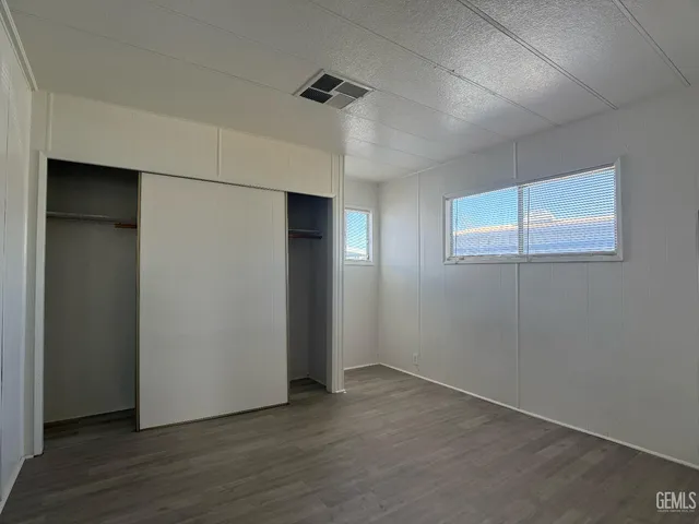 an empty room with wooden floor