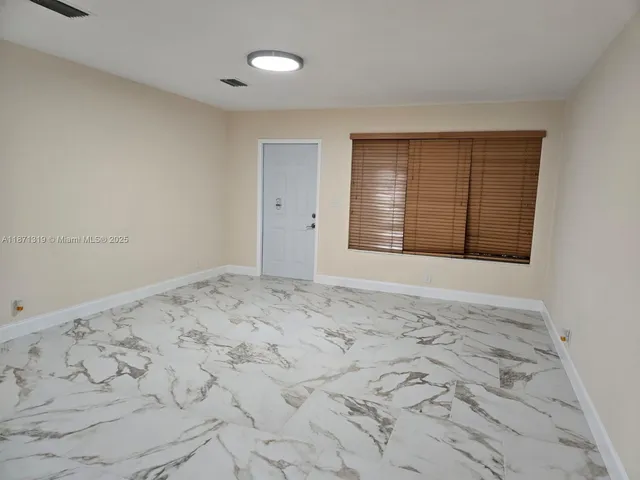 a view of an empty room and window