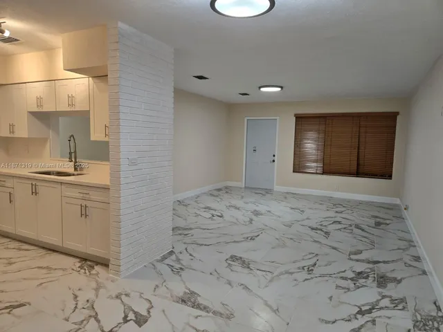 a view of a kitchen with a sink