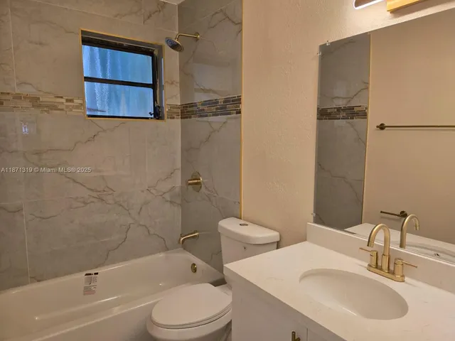 a bathroom with a toilet a sink and bathtub