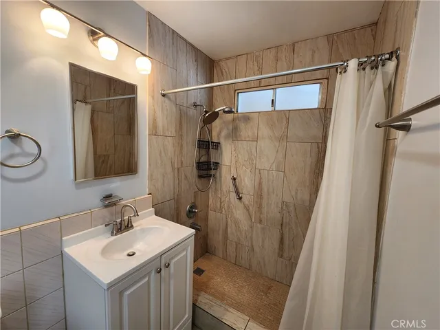 a bathroom with a sink mirror vanity and toilet