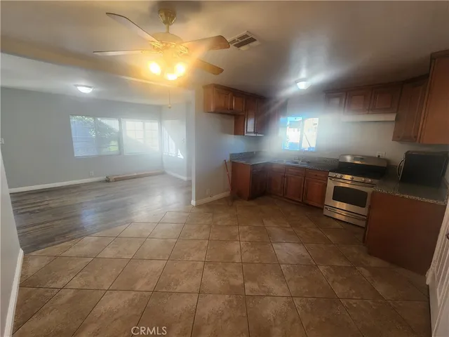 a kitchen with stainless steel appliances granite countertop a sink and cabinets