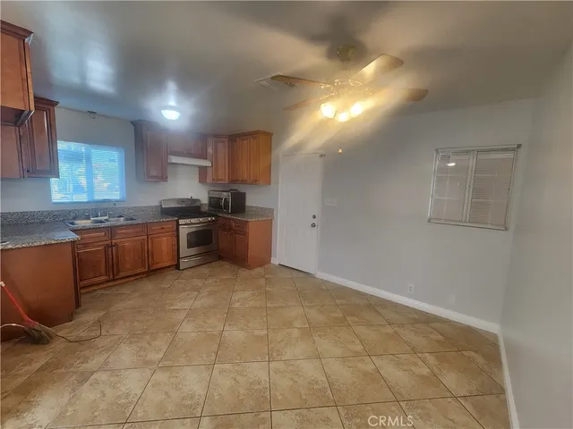 a kitchen with stainless steel appliances granite countertop a stove a sink and a granite counter tops