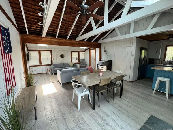 a view of a dining room with furniture wooden floor and a rug