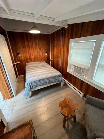 a bedroom with a bed and a mirror