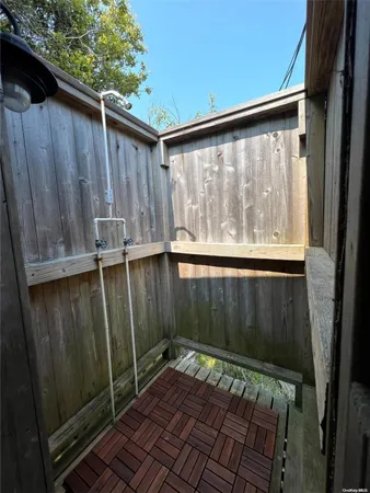 a view of a roof deck with wooden floor and fence