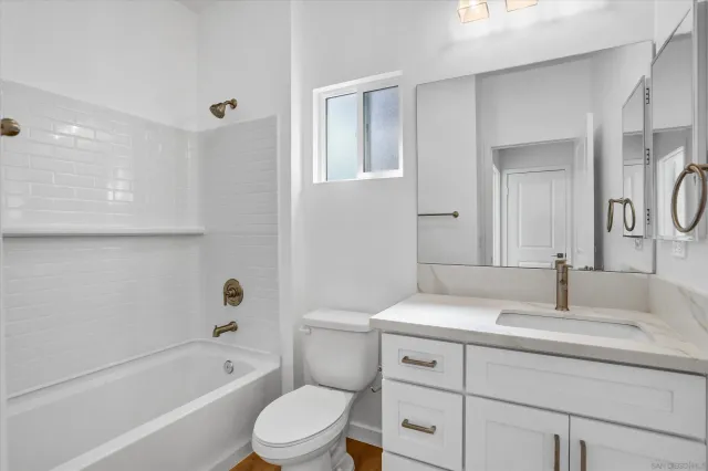 a bathroom with a sink a toilet and bathtub