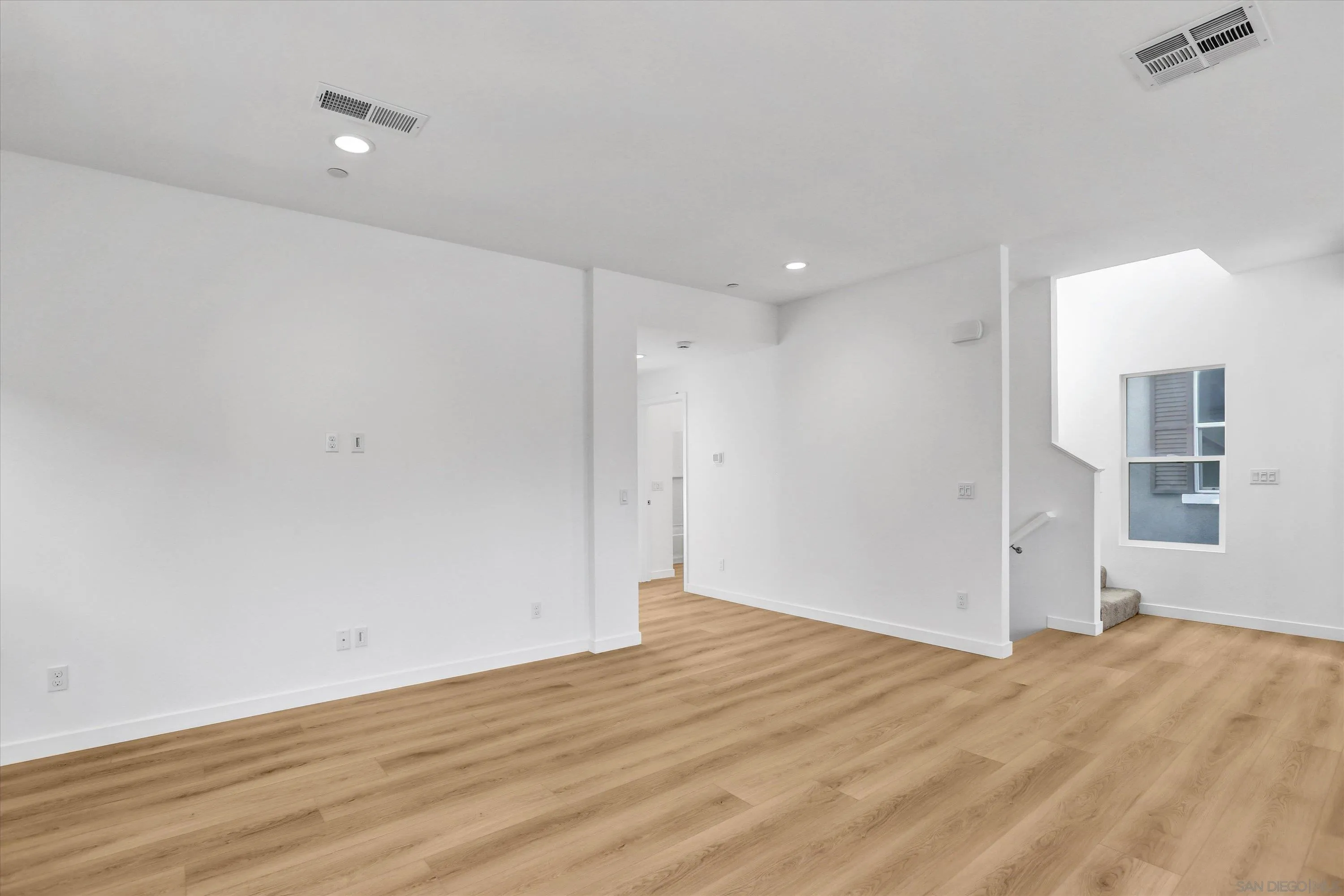 8540 Vista Azul Lemon Grove, CA 91945 - Photo 20 of 33 a view of empty room with wooden floor and windows