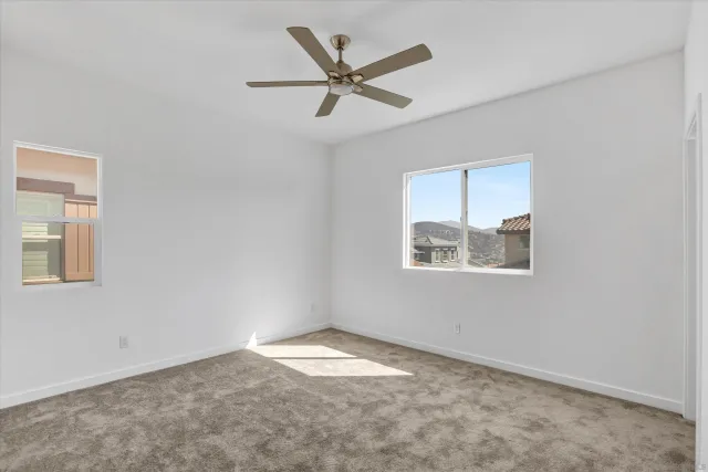 a view of empty room with ceiling fan